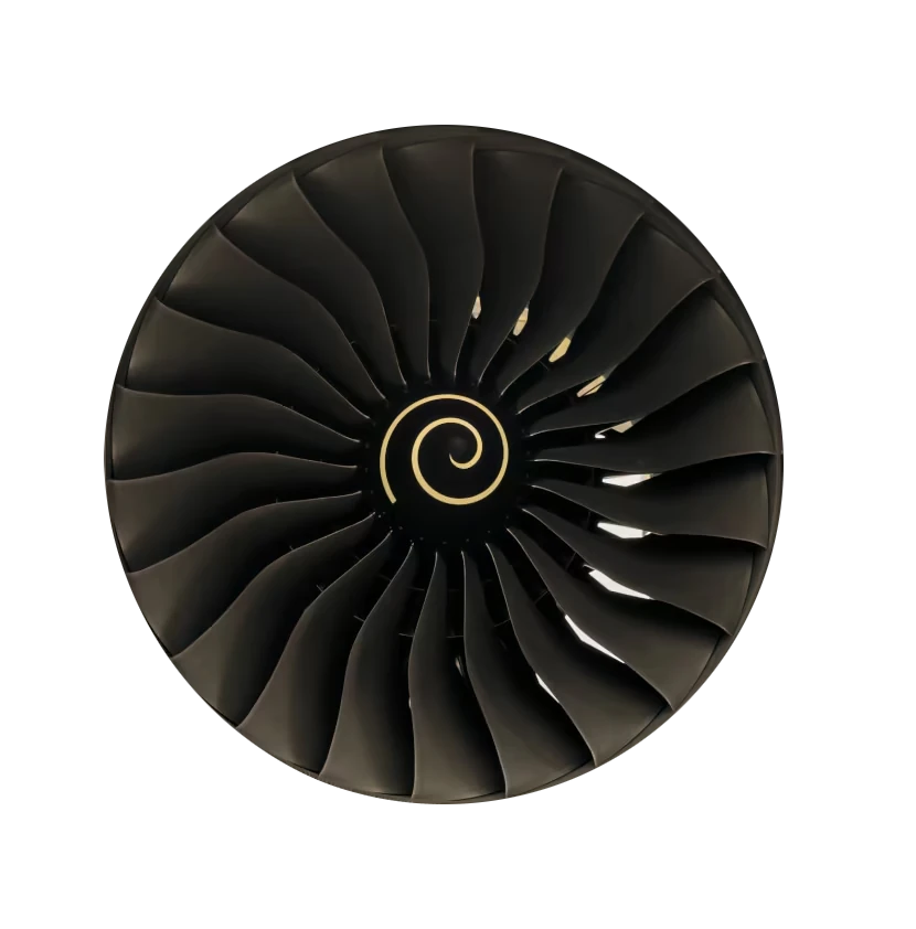 A front view of a jet engine fan with multiple dark blades arranged in a circular pattern and a spiral design at the center.